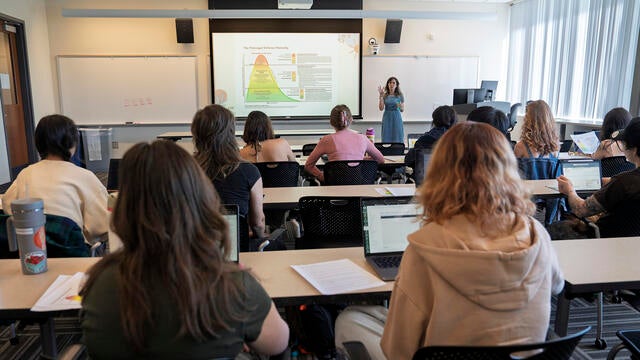 a professor teaches students in a classroom